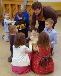 Margot and kids doing a music activity during First Hour.